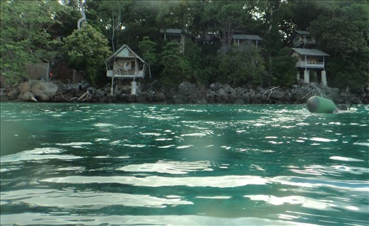 Dave snorkelling at Iboih, Sabang with bungalows in background.