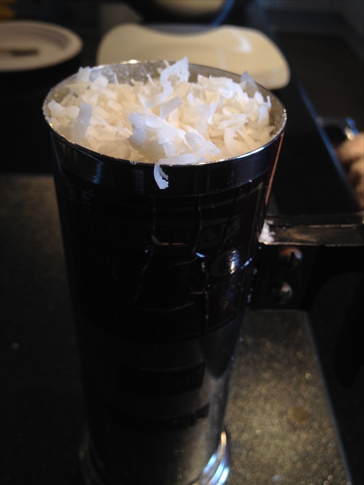 fill puttu maker with puttu and coconut flakes