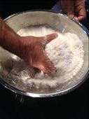 Mixing puttu: rice flour, salt, coconut flakes and water with hand: by adventuresofachildlikewonder, Views[1962]