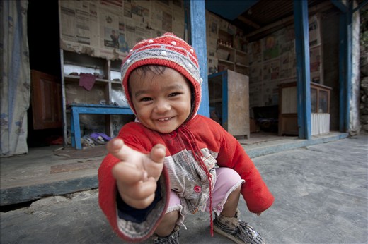 A Nepali child is always welcome visitors with smiles and asking for candies.