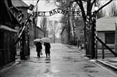 ‘Labor Makes you Free’. Two women pass through the entrance to Auschwitz I – a concentration camp from World War II located in Poland. The site has since been converted into a museum which tells the story of the horrors faced by those taken there. : by afn, Views[1245]