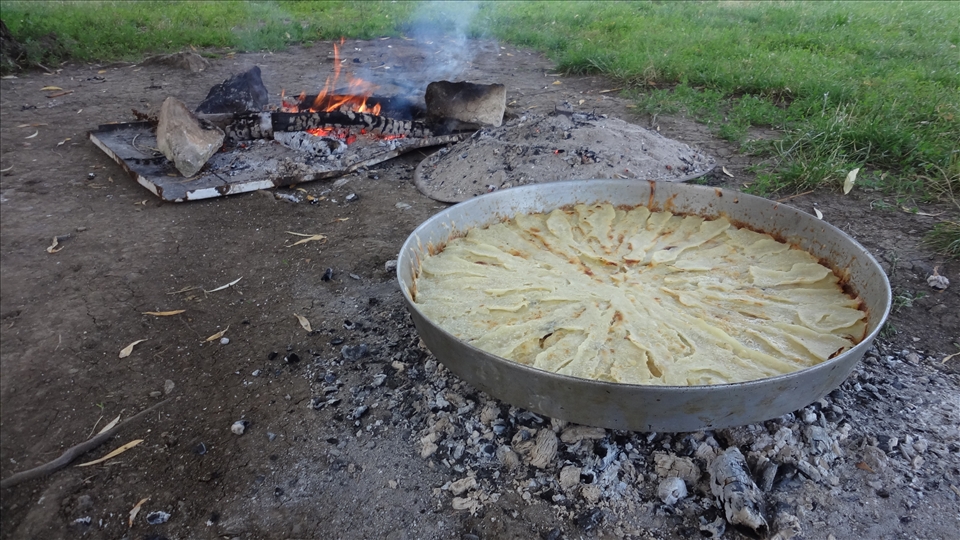 PHOTO-III:
This photo shows the final product. This flija is made for four persons. The whole process takes more than 3 hours, but it depends in how many persons it will be prepared for and some other factors. Filled baking pan stands for a while over the fire sparks for a further baking. And finally, flija is ready to be served. Bon appetit! 

