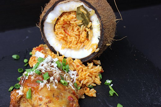 Jollof Rice Serve in Coconut with baked chicken.