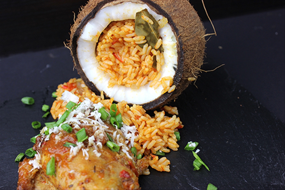 Jollof Rice Serve in Coconut with baked chicken.