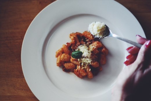 adding parmesan cheese to the ricotta gnocchi and ready to eat 