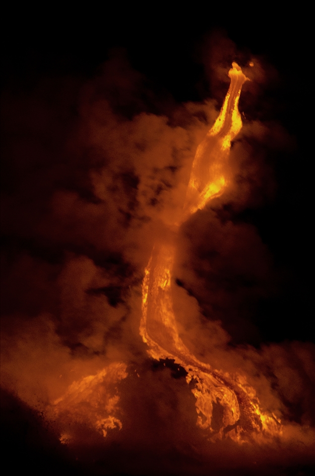 The lava is flowing down from what looks to be a dragon's mouth. Steam rises from the molten lava as it hits the oncoming waves. Moments later, a large piece brakes off and changes the path of the flowing lava. 