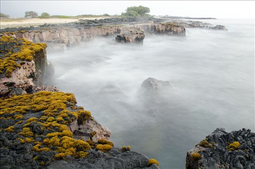 Shoreline haze as the waves crash and the water recedes. 