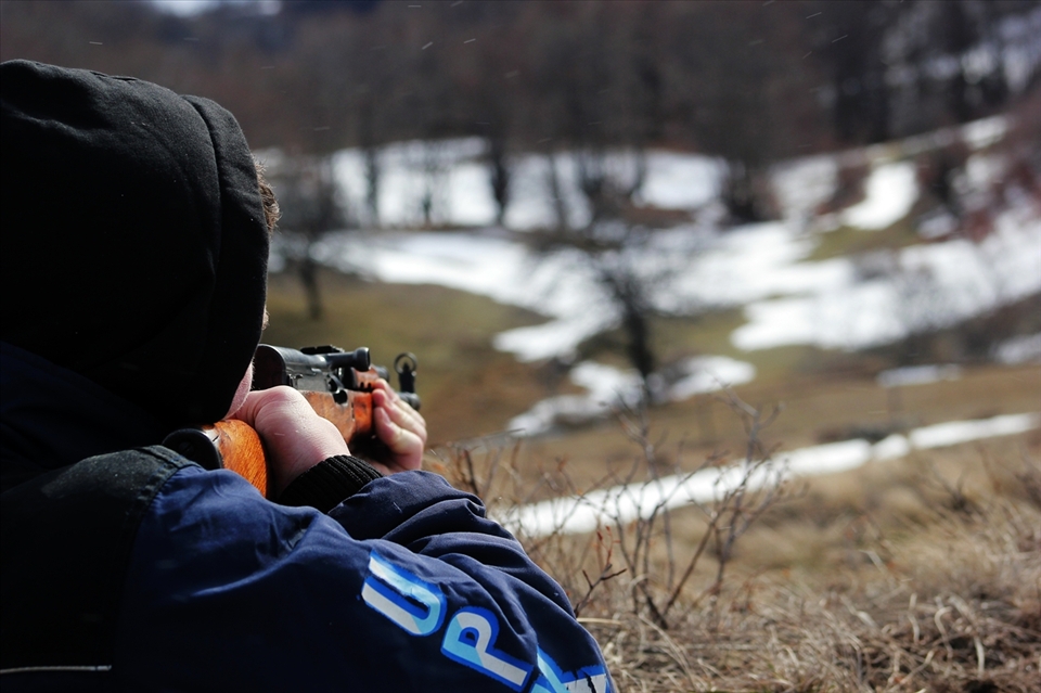 A young hunter shoots to the animals