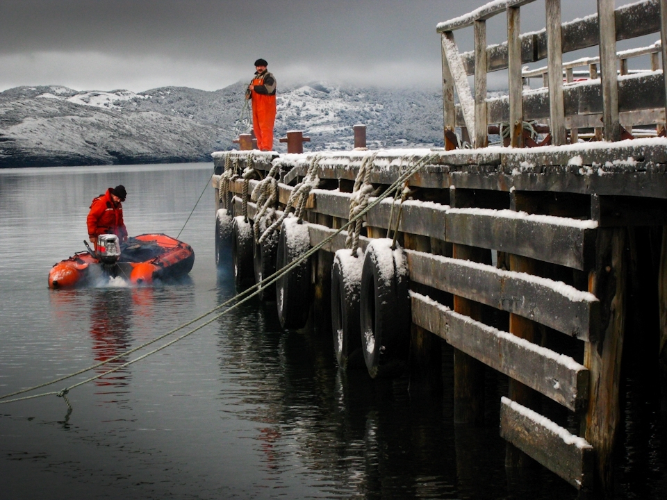 Cattle ranching in some of the most remote regions of Chile comes with its challenges. While pastures are plentiful and grass is green for the cattle, getting to an estancia - or ranch - accessible only by water becomes increasingly difficult in winter as temperatures drop below freezing. These workers prepare the small outboard motorboat for the two hour trip navigating the fjords of Last Hope Sound (Sena Ultima Esperanza) and then the large Serrano River before arriving back at the estancia.