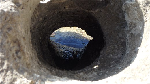 Hole in a rock (there's a visible crab in the hole)