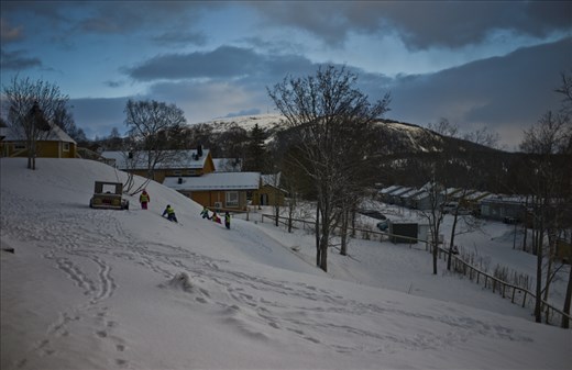 Children play outside the Brnehage in the village of Hemnesberget.