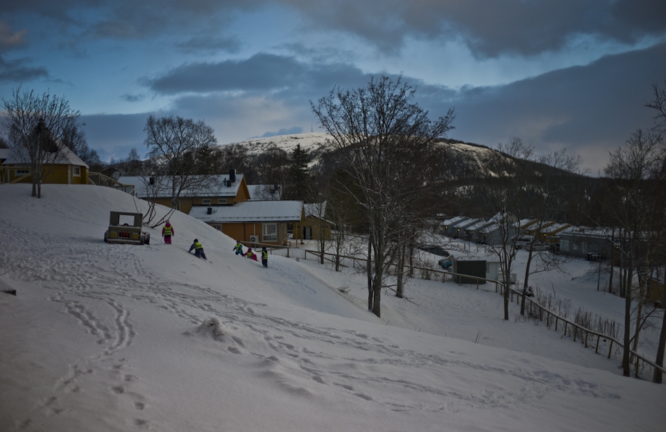 Children play outside the Brnehage in the village of Hemnesberget.