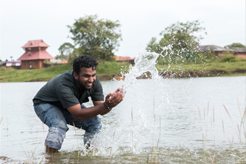 My friend playing with water at Madayi Kavu or Madayi Temple.
