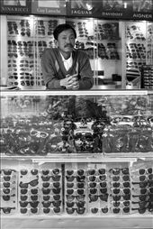 A Vietnamese man waits for a sale at his sunglass shop: by akalili, Views[359]