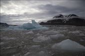 A few years back you couldn't see these mountains.  In bays such as this, where carvings are so frequent the sound is deafening and the glacial wall is blue from all the new chunks of ice breaking free that it becomes easy to see how small they are getting.  Slowly moving along, with the pop and crackle of ice around us, the ruts in the hill side speak of how much height and length has been lost from the glacier. : by akbudden, Views[487]