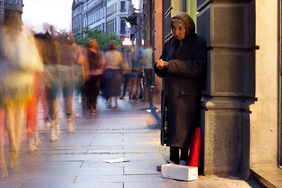 In ths one I've tried to show how many peope pass near her in just half second and only 2 of them give her some charity per hour. She waits like that till midnight, this was my last photograph so in gave her some money, heard her story and left.