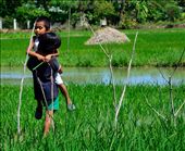 These two kids are from our barangay and they are motherless already. Big sister carrying her little brother who is sick and making sure his feet not get wet .: by akoayinhinyero, Views[1130]