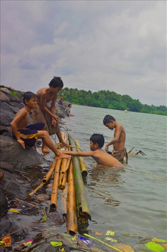 On the left side of our port are children that are looking for scraps to sell.