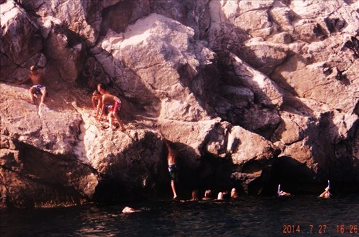 [Together we troop, we make it, we fall.] I was sitting in my kayak when I spotted Greek children cliff-diving - a common summer adventure in Santorini. The ocean is a contrast to the twisting distortion of a cliff in every way. I hear their sweet laughter from afar, and snap this photo just before the boy at the top plunges forward to be hugged by cool waters.