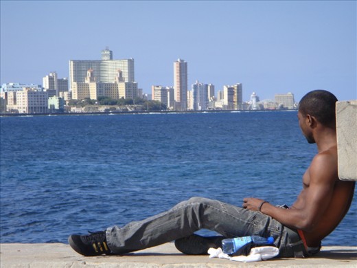 A young Cuban relaxing in Malecon dreaming of a life that  he probably doesn't even want while the time slowly passes by....