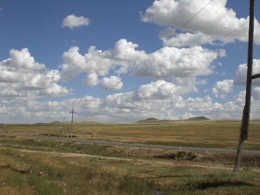 Mongolia is a big country, and not very developed in many areas. The solitude of its landscapes is amazing and eye-capturing. The overhead cables and the road add a contrast touch.