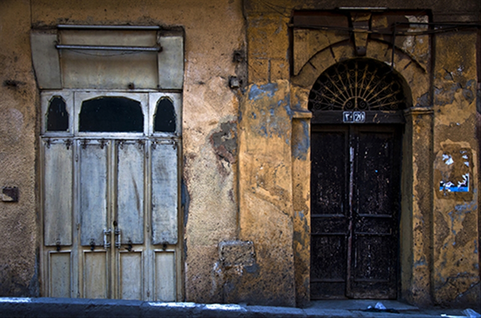 Two doors from two different eras that Al Darb Al Ahmar has witnessed.