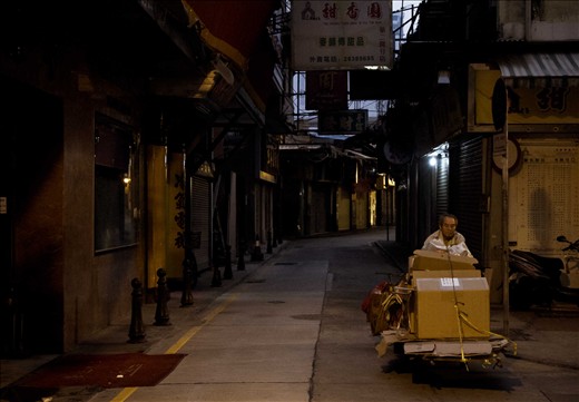 Macau, China - A man gets ready to go to work early in the morning along St Paul's Road in Macau a few days before the start of the New Year of the Gregorian Calendar.