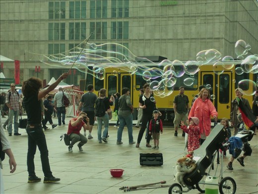 Street artist blowing huge soap bubbles. August 2010, Berlin, Germany