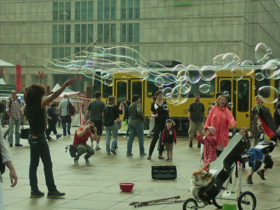 Street artist blowing huge soap bubbles. August 2010, Berlin, Germany