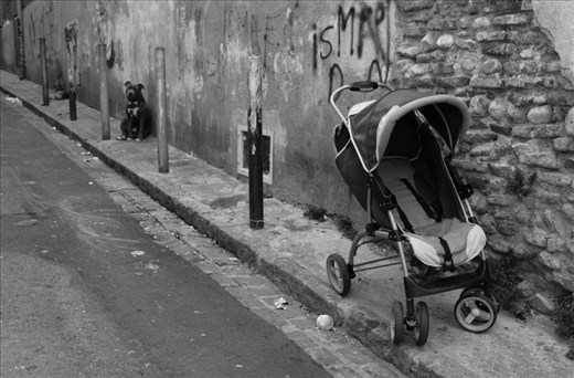 PRAM BARK, Perpignan, France: An empty pram adds a ghostly and deserted post apocalyptic feeling to the already depressing streets. Capping off the sadness, we see stray dogs chained to polls, with no owners in site. 