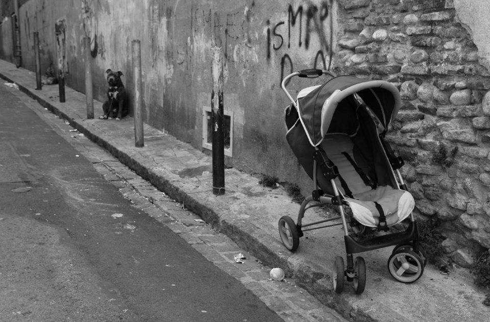 PRAM BARK, Perpignan, France: An empty pram adds a ghostly and deserted post apocalyptic feeling to the already depressing streets. Capping off the sadness, we see stray dogs chained to polls, with no owners in site. 