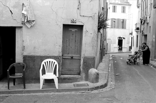 MOTHER HAS LEFT, Perpignan, France: An elderly lady minds a small child amongst the derelict and undoubtedly unhygienic  streets. This was one of the only prams I saw with a child actually inside it. Because this community is so segregated from the mainstream, their lifestyle is viewed as 'unacceptable', and 'unsustainable' by French locals.   