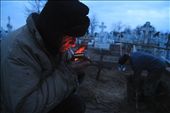 Pavel Hancearencu, the town's gravediggers in Sulina, lights a cigarette while his nephew, Augustin Hriscenco, takes turn on digging the grave for the next day funeral, on Christmas Eve. Sulina, Danube Delta, Romania.: by alext, Views[568]