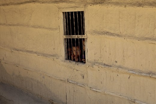 Children in their house as behind bars in this village near the jungle.