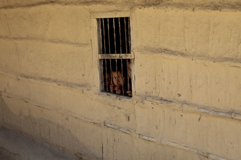 Children in their house as behind bars in this village near the jungle.