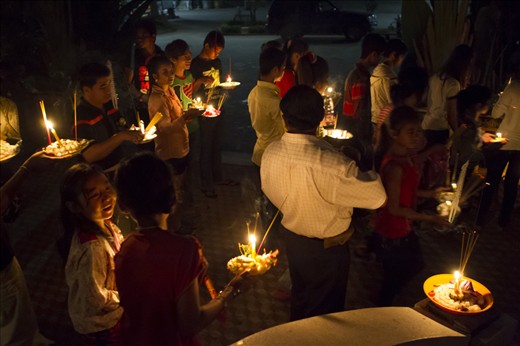 Young and old devotees gather at 4am for morning offerings procession at temple.