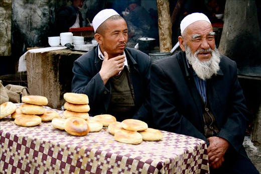 Uyghur men at a bazaar stall, Kashgar