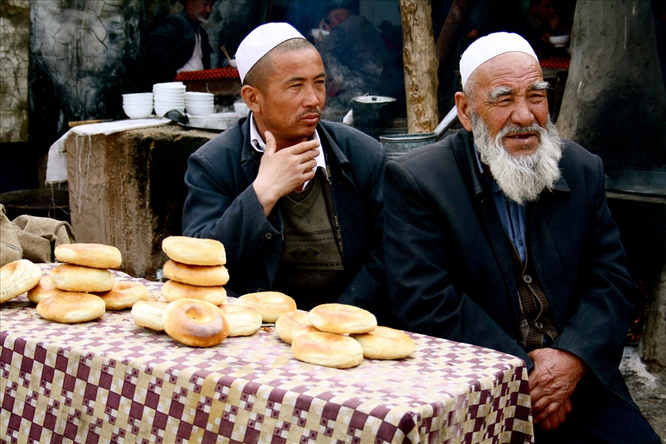 Uyghur men at a bazaar stall, Kashgar