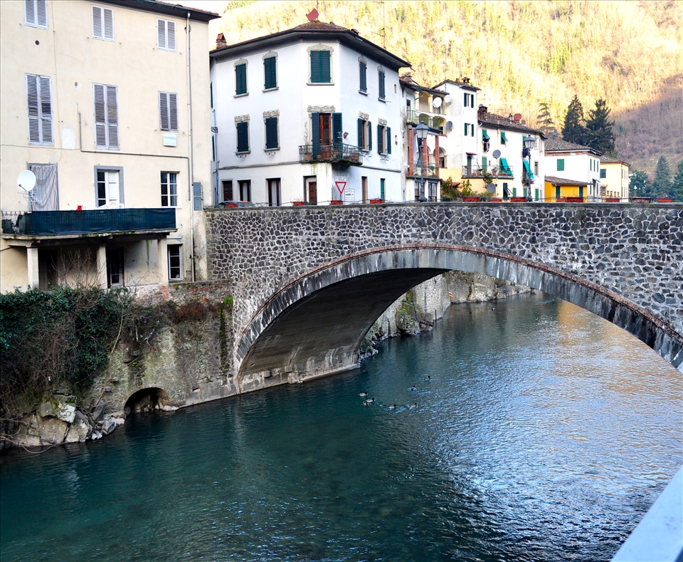 The fresh blue water travels down stream through an old, classic village Bagni Di Lucca