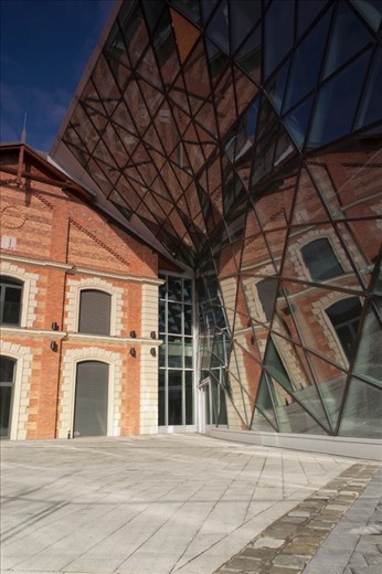 An old bulding situated on the Budapest riverside, with a modern glass attachment.