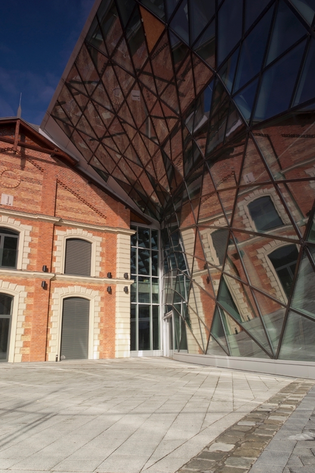 An old bulding situated on the Budapest riverside, with a modern glass attachment.