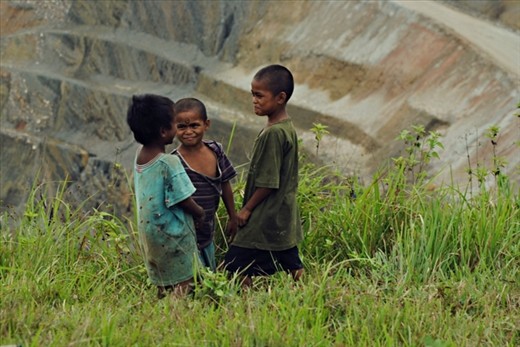 An admirable view of an open-pit copper mine site from a laid back playground.