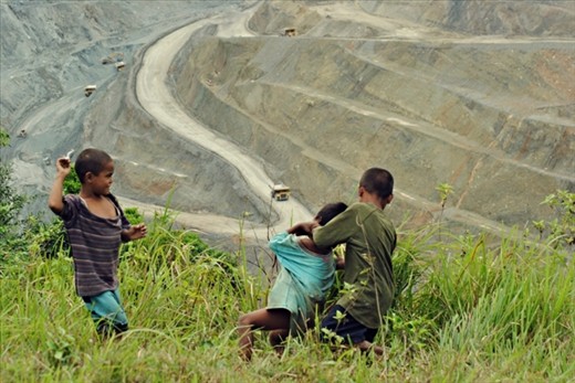 Main haul road of a copper mine open-pit dominating the kids’ playground view.