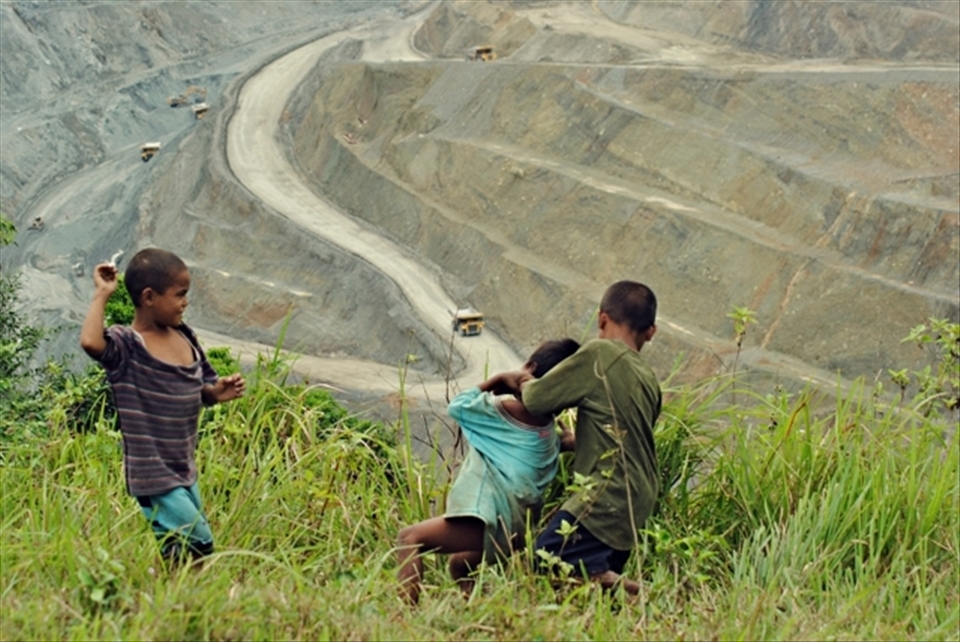 Main haul road of a copper mine open-pit dominating the kids’ playground view.