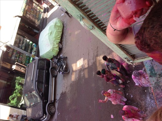 From the hotels window, throwing some water to the people passing by