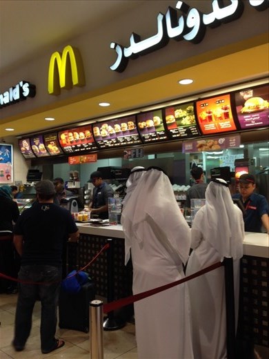 Men dress like Arab prince from a holiwood movie... Buying at McDonald's 