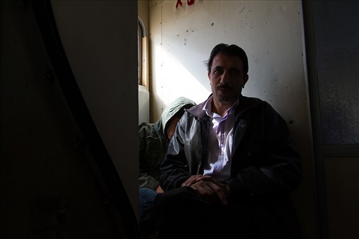 A man and his son have no tickets and have to sit in the cramped head area of the wagon next to the toilet. Second and third class wagons/trains are anything but comfortable even for the passengers with tickets. 