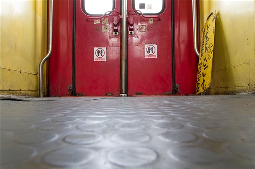 A train is at a small station en route to Mashhad. These old trains were acquired second-hand from European countries many years ago. A yellow sign reads “Tehran-Mashhad, Salon 11”. The 860 km-trip (535 miles) takes about 14 hours. Sheets, blankets and pillows are provided to ‘6-bed first class’ passengers.