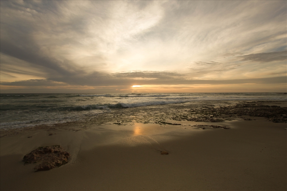 As the tide subsides, the sun makes her way to bed for the day