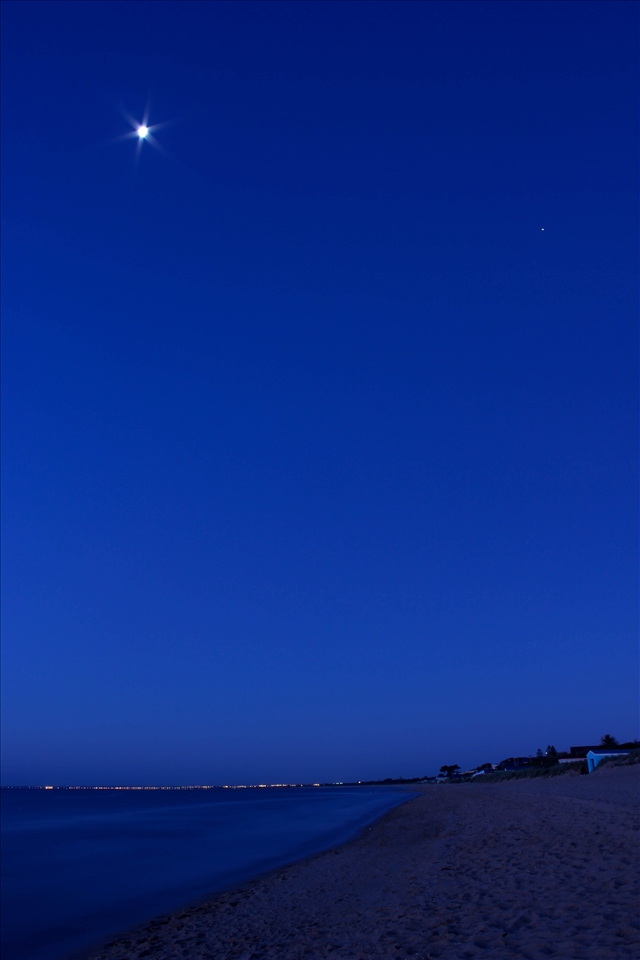 The moon takes her place in the sky, alongside Jupiter, amongst vivid blues